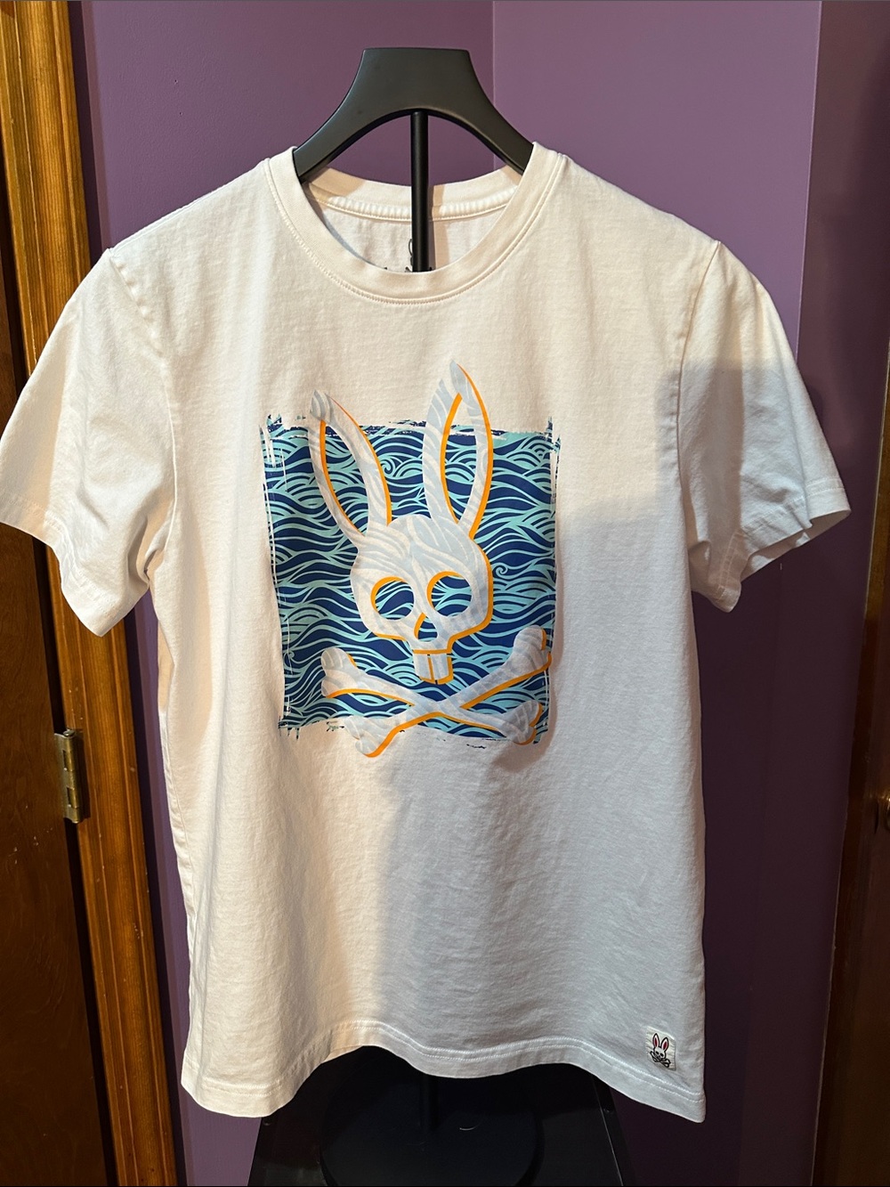 Psycho Bunny White Tee with Blue Wave and Orange Accent Graphic